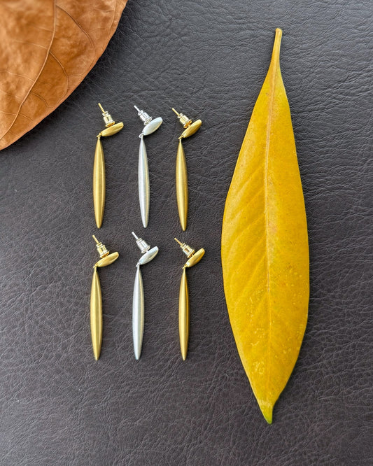 Refla Leafline sculptural earrings in matte gold and silver with leaf-shaped silhouette