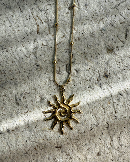 Sculptural gold jewelry inspired by sun spirals