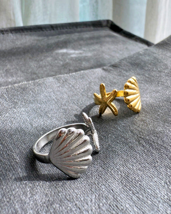 Shell & Starfish Ring in gold and silver finish on fabric background